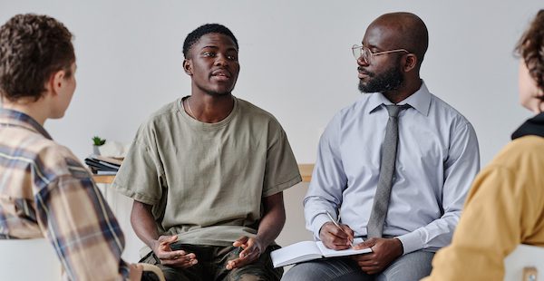 Adolescent male speaking with a counselor